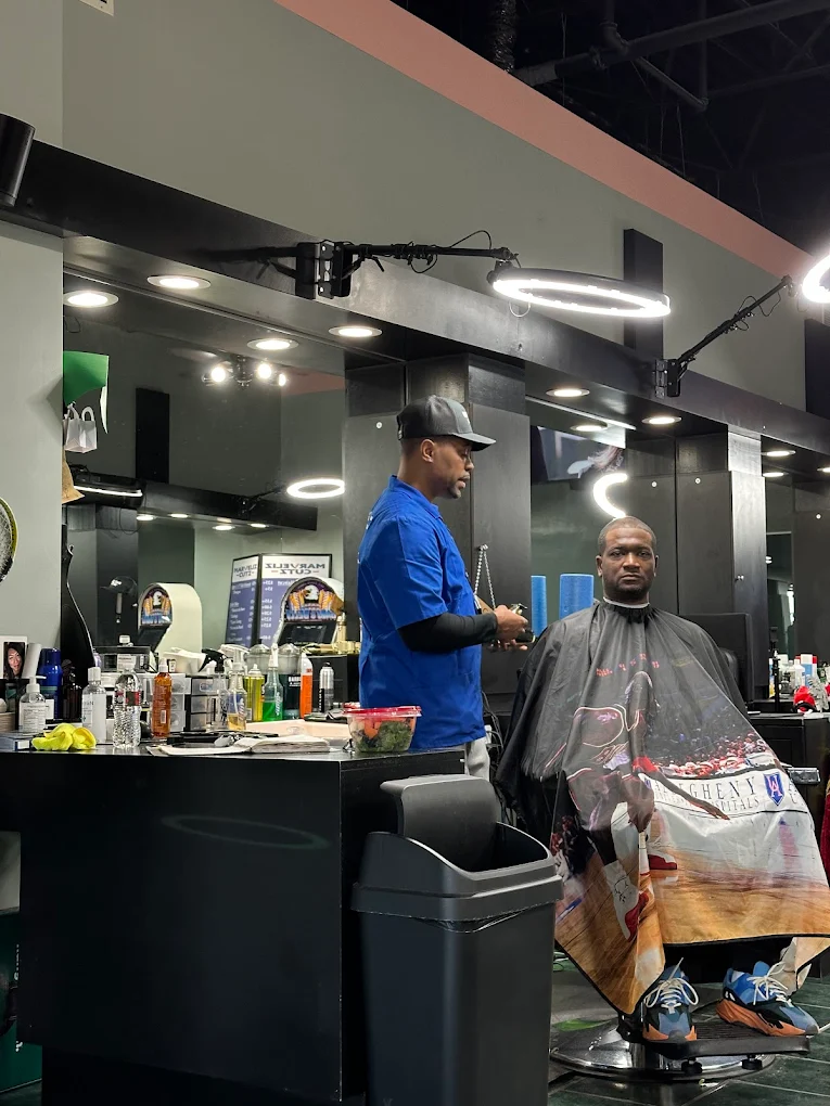Ron Baggett cutting a client's hair at Marveliz Cutz